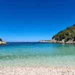 Dafnoudi Beach with clear turquoise waters and rocky surroundings.