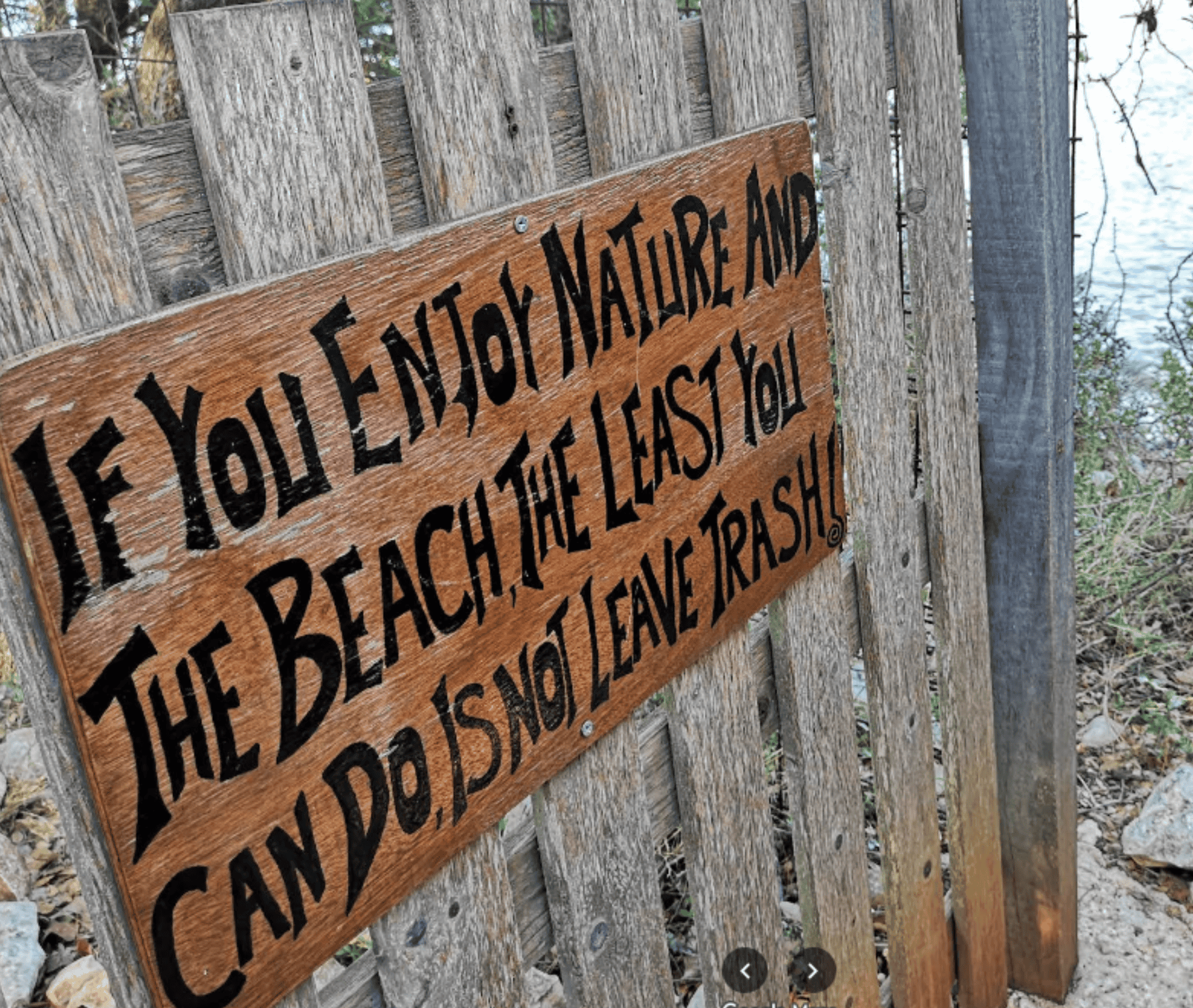 Sign at Emplisi Beach reminding visitors to protect nature and avoid trashing.