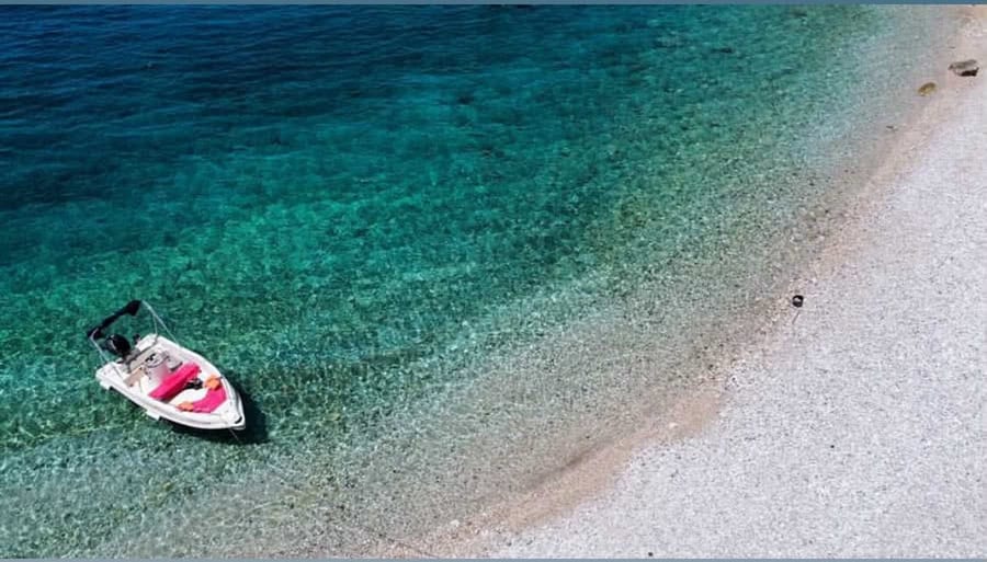 Boat anchored in clear blue waters near Fiskardo.