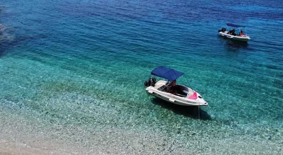 Speedboat anchored in turquoise waters near Fiskardo.